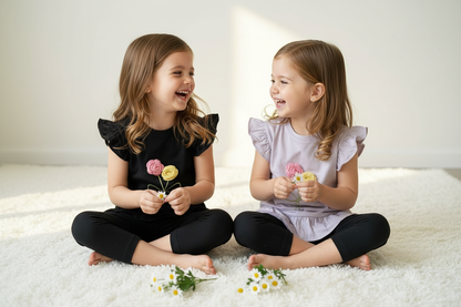 Twins sitting on floor playing - below knee leggings