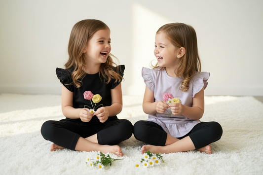 Twins sitting on floor playing - below knee leggings